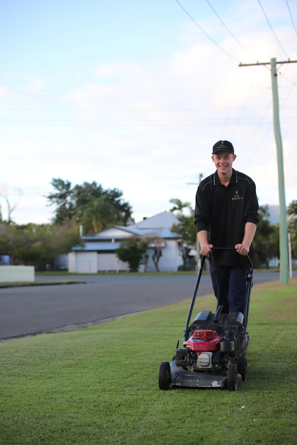 Lawn mowing Rockhampton - Millzy's team operating professional mowing equipment on residential property